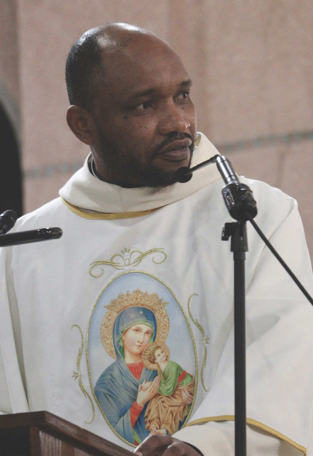 Father Luc preaching from the ambo