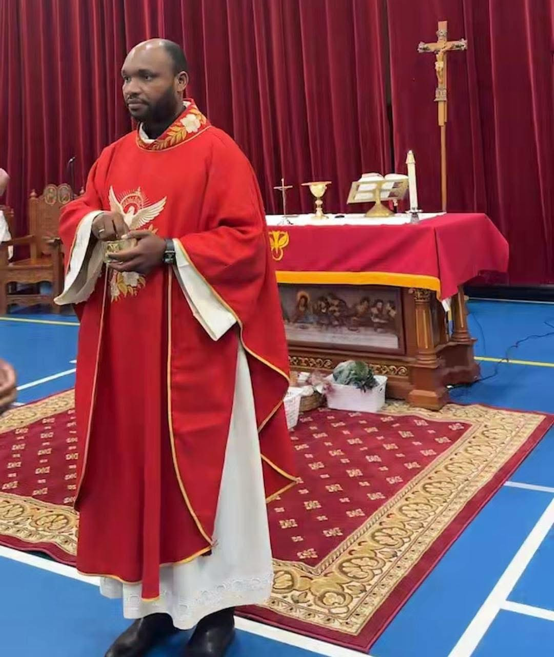 Father Luc celebrating Mass in red vestments